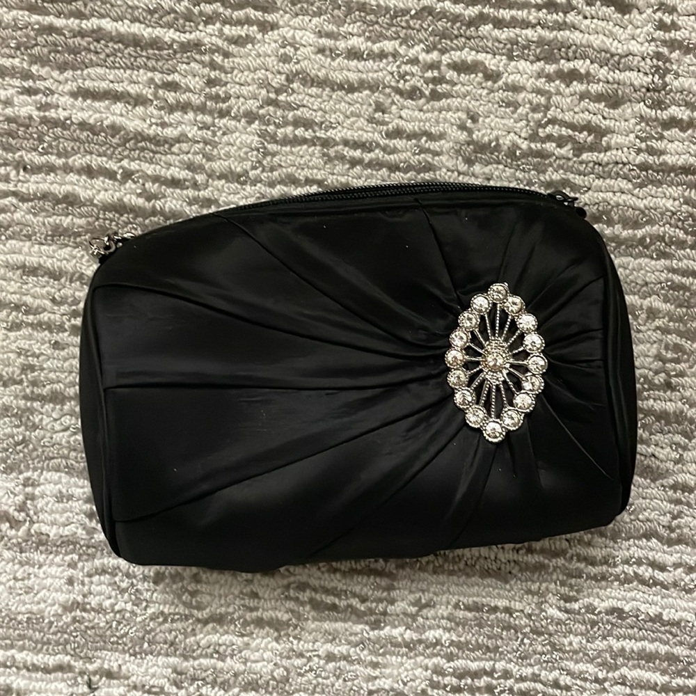 Black satin clutch with rhinestone broach detail